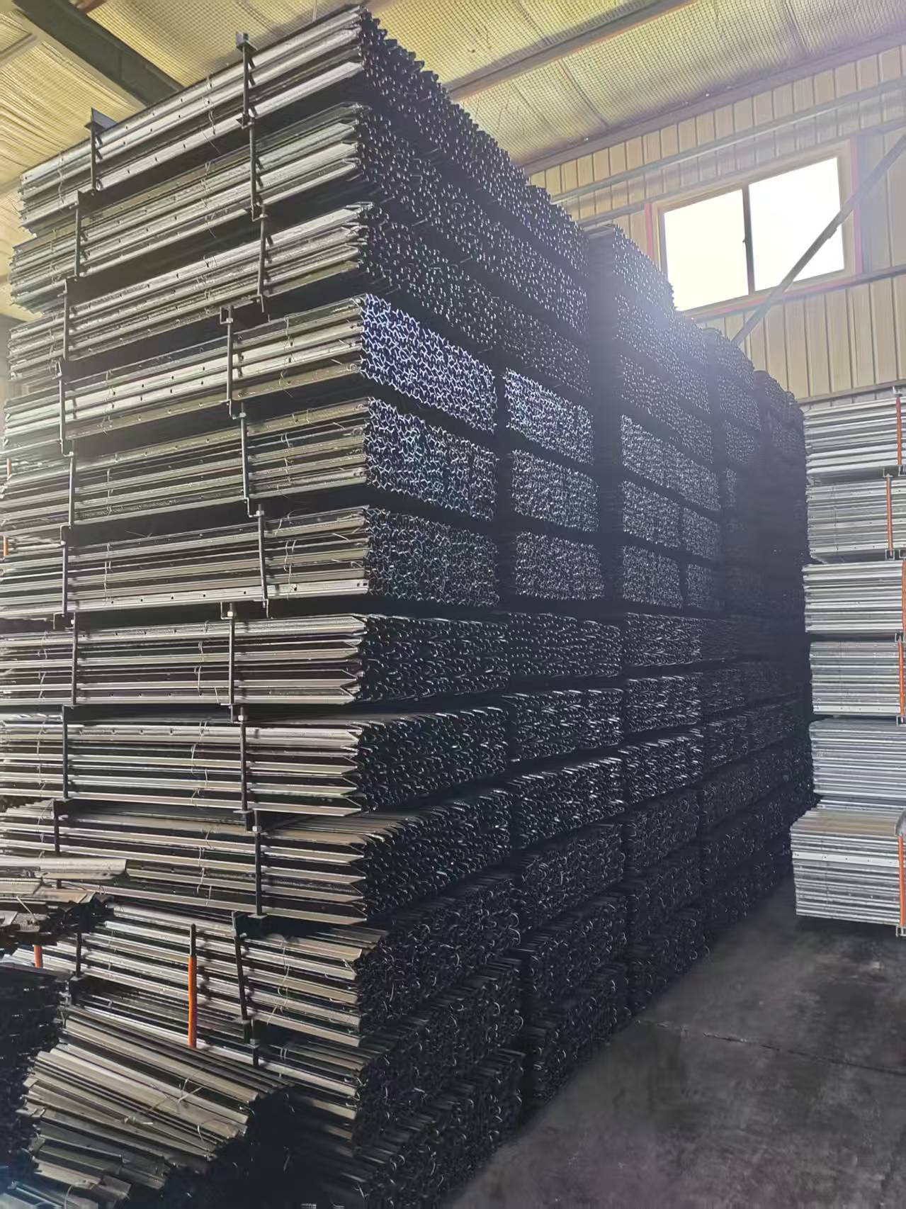 Black-painted star droppers bundled and stacked at the supplier warehouse